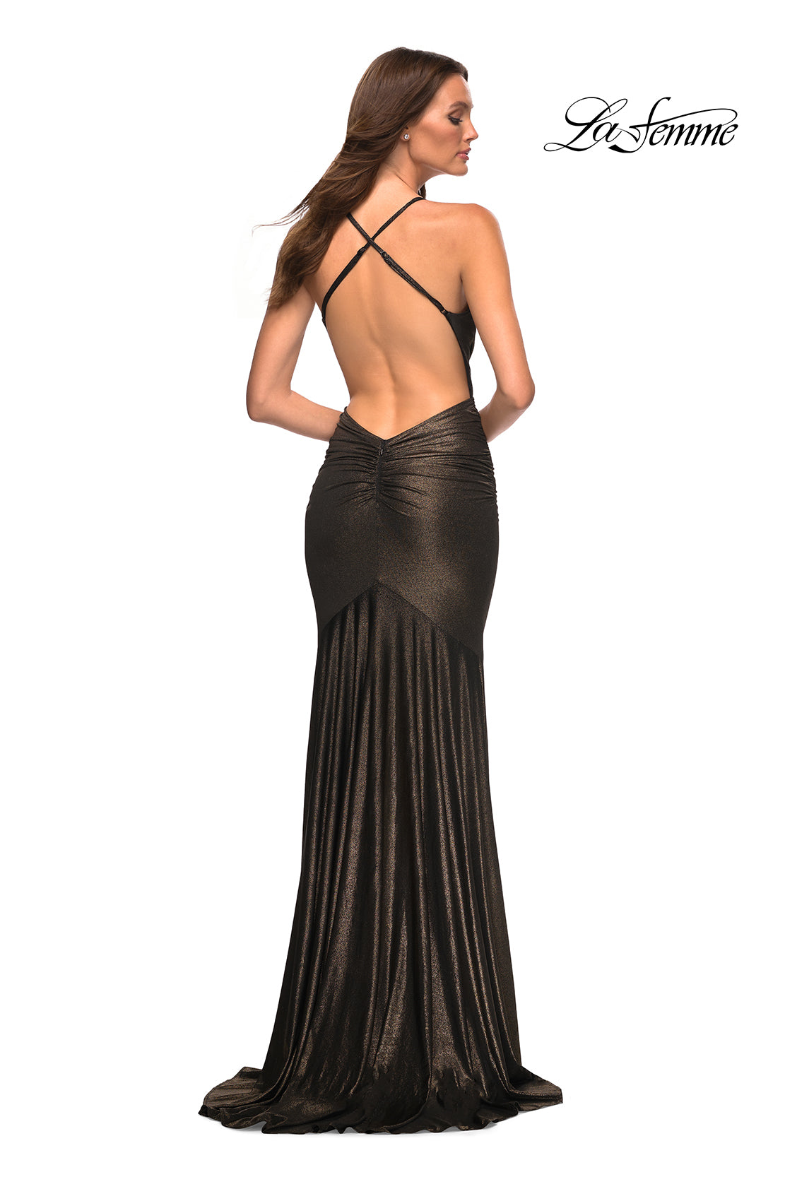 A woman stands facing away in a floor-length metallic black La Femme Open-Back Long Metallic Prom Dress with crisscross straps. Perfect as a long prom dress.
